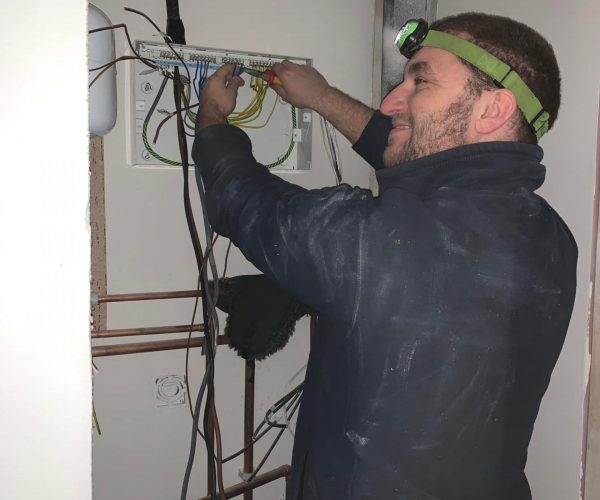 Electrician working on fuse box replacement - Full Circuit Electrical