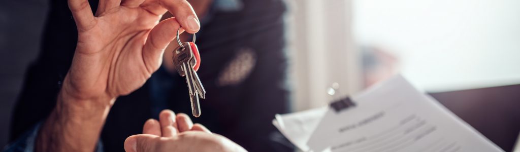 Estate agent passing keys to new homeowner - Full Circuit Electrical