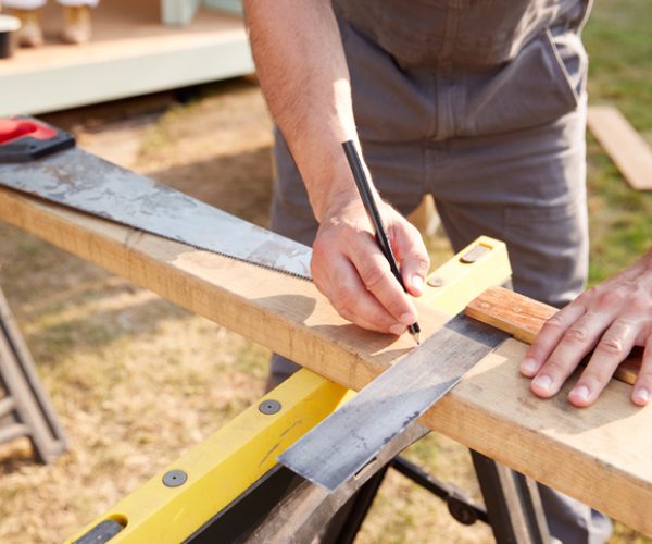 Carpenter Measuring Wood
