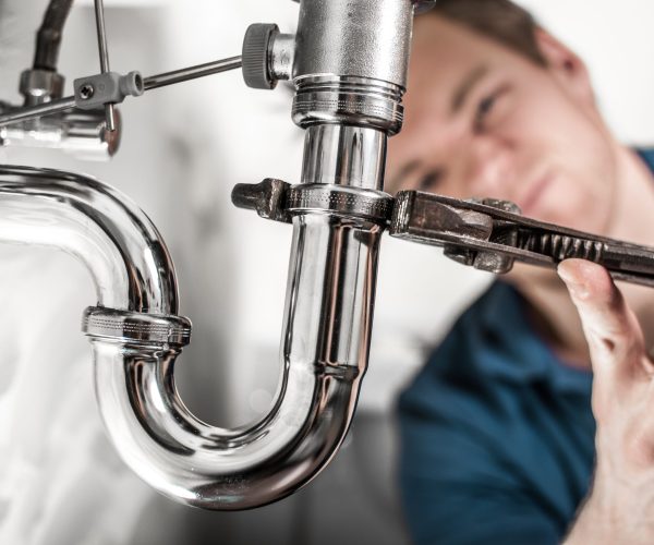 Full Circuit Plumber Fixing A U-Bend